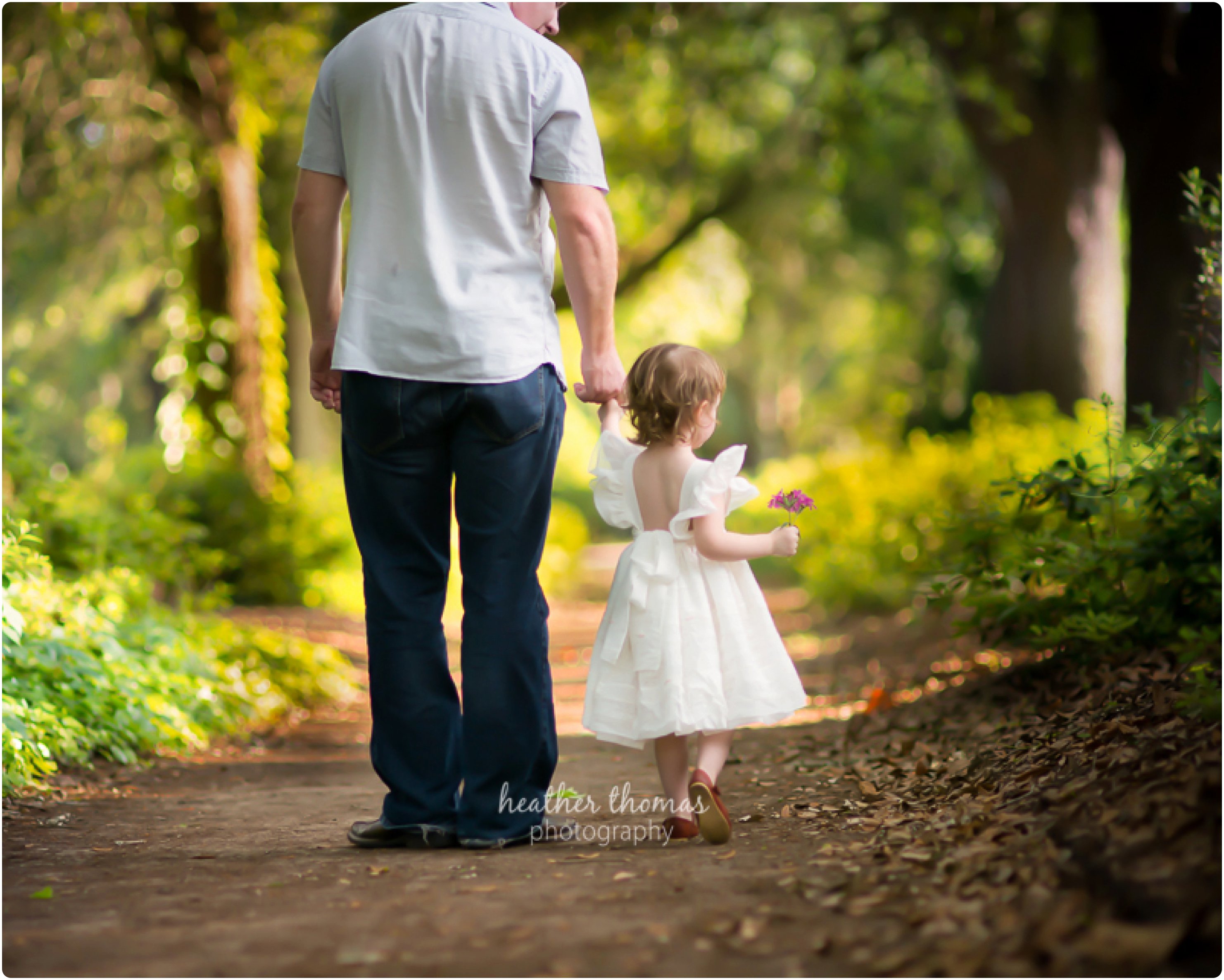 What to Wear for a Family Photo Shoot // Philadelphia Family Photography dad and toddler daughter walking in park photo by heather thomas photography