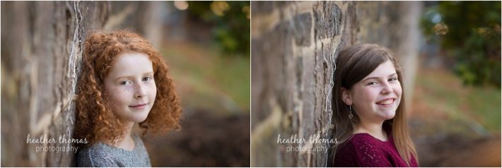 The B Family | Newtown, PA Family Photography two girls leaning against a stone wall outside in bucks county pa