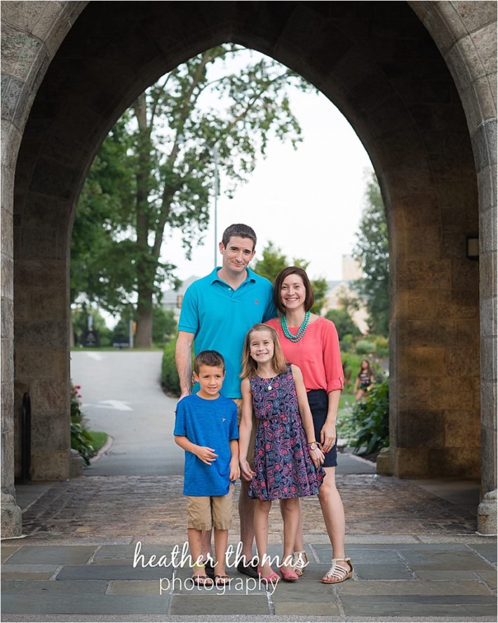Family Photography at Bryn Athyn in Philadelphia family standing underneath the cathedral arch at bryn athyn philadelphia