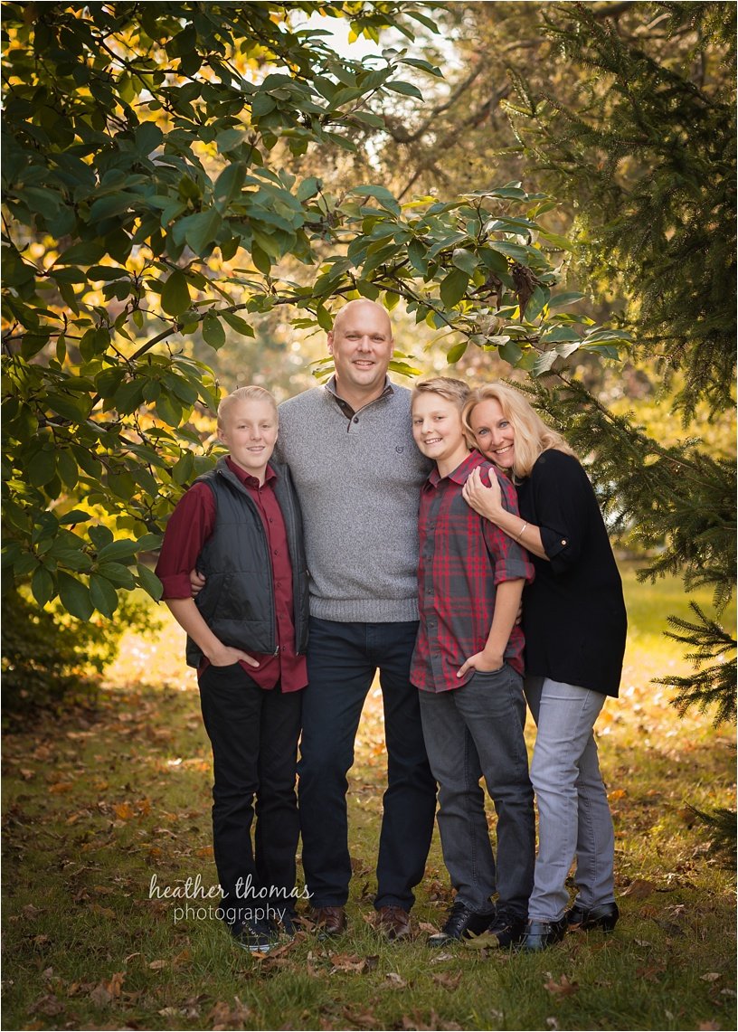 fall photo shoot philadelphia-42.jpg brothers wearing maroon and black with their parents outside for a fall photo shoot in newtown pa