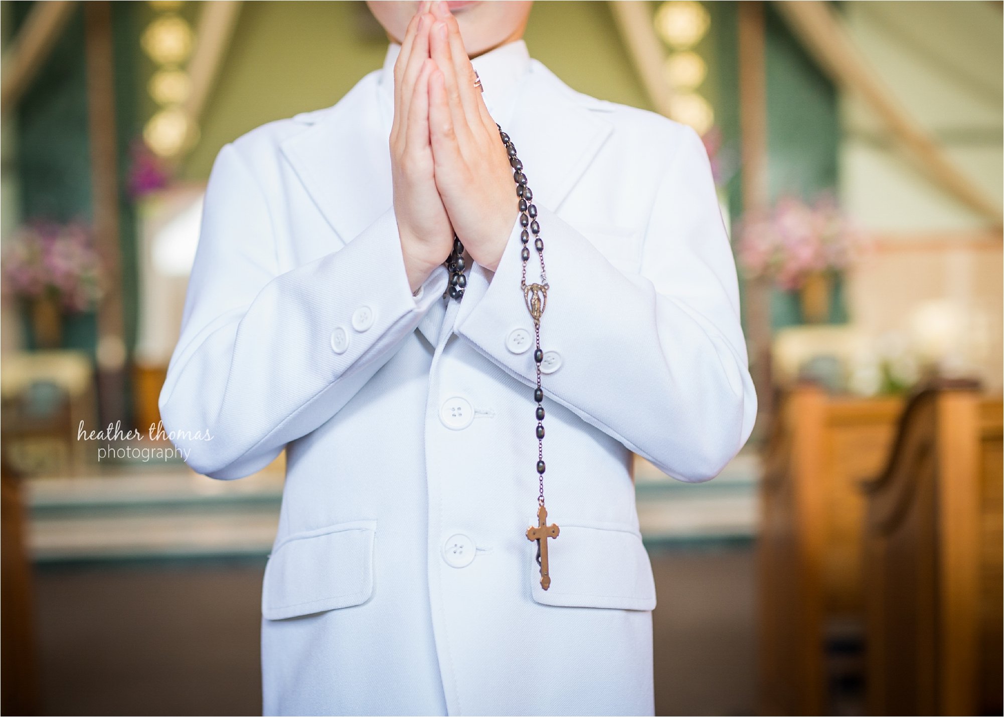 Newtown pa communion photography-19.jpg a boy dressed in white holding rosary bead inside st andrews church in newtown