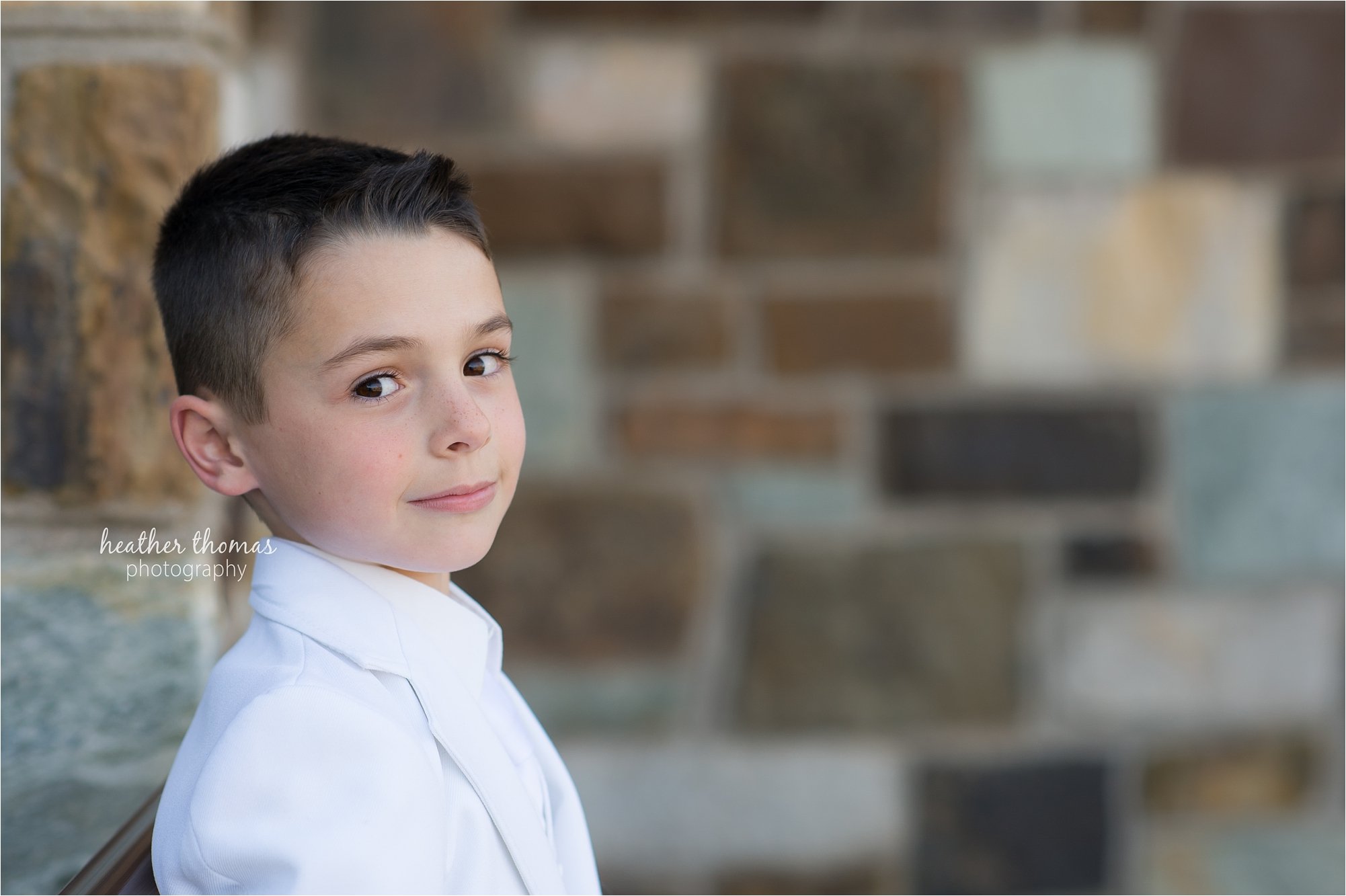 Newtown pa communion photography-32.jpg a boy dressed in white for his first holy communion in newtown pa