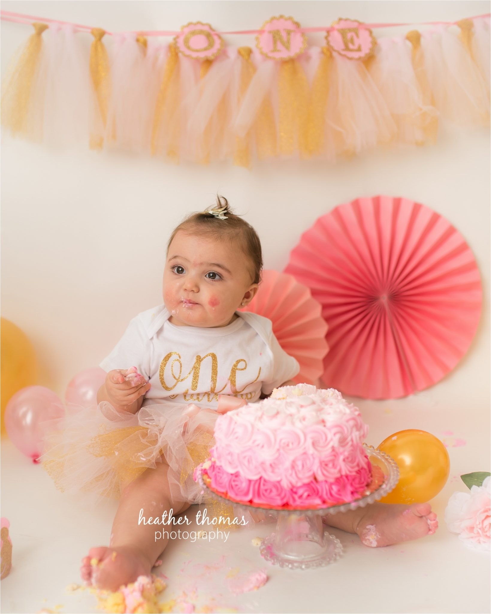 bucks county first birthday photographer-78.jpg a picture of a one year old wearing white at a cake smash photo shoot in newtown pa
