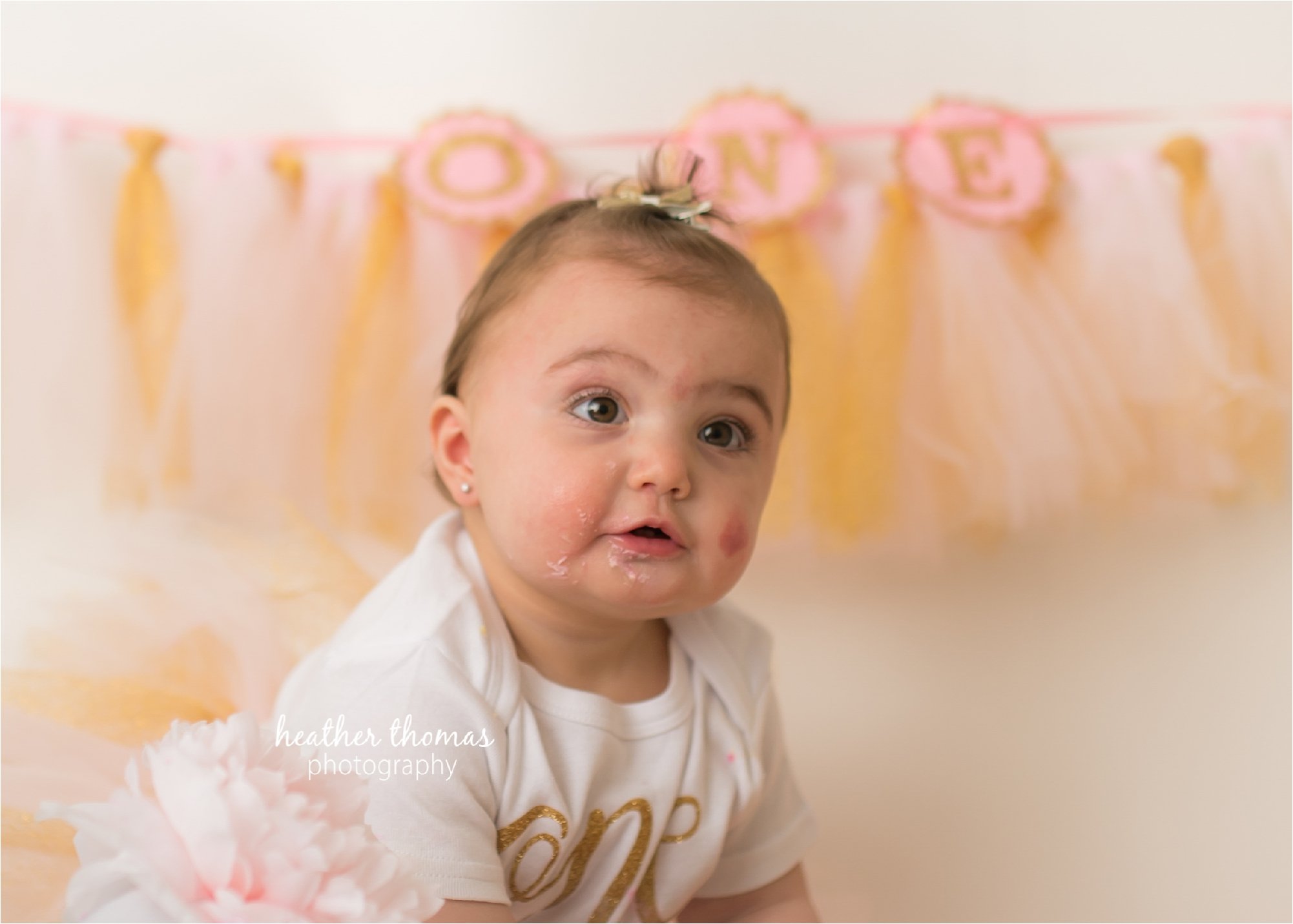 bucks county first birthday photographer-83.jpg a picture of a girl looking at the camera during a cake smash photography session in bucks county pa