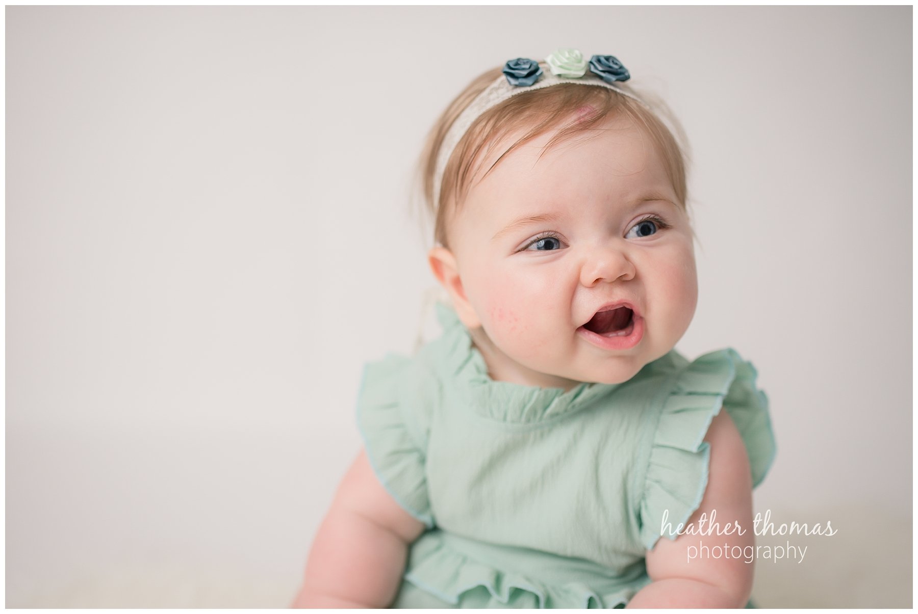 baby photo shoot philadelphia-1.jpg a 6 month old baby wearing teal smiling for camera