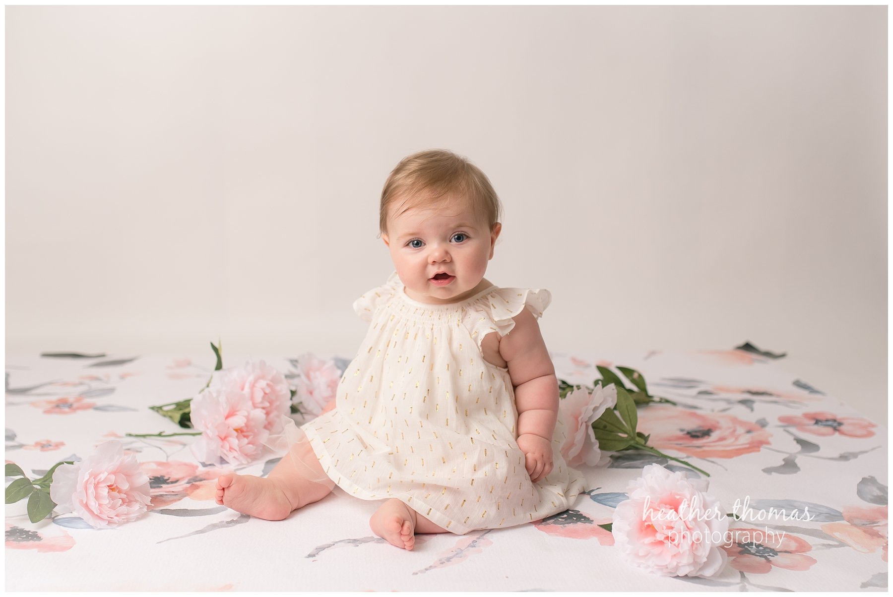 baby photo shoot philadelphia-22.jpg a 7 month old looking at the camera sitting on a pink backdrop in newtown pa