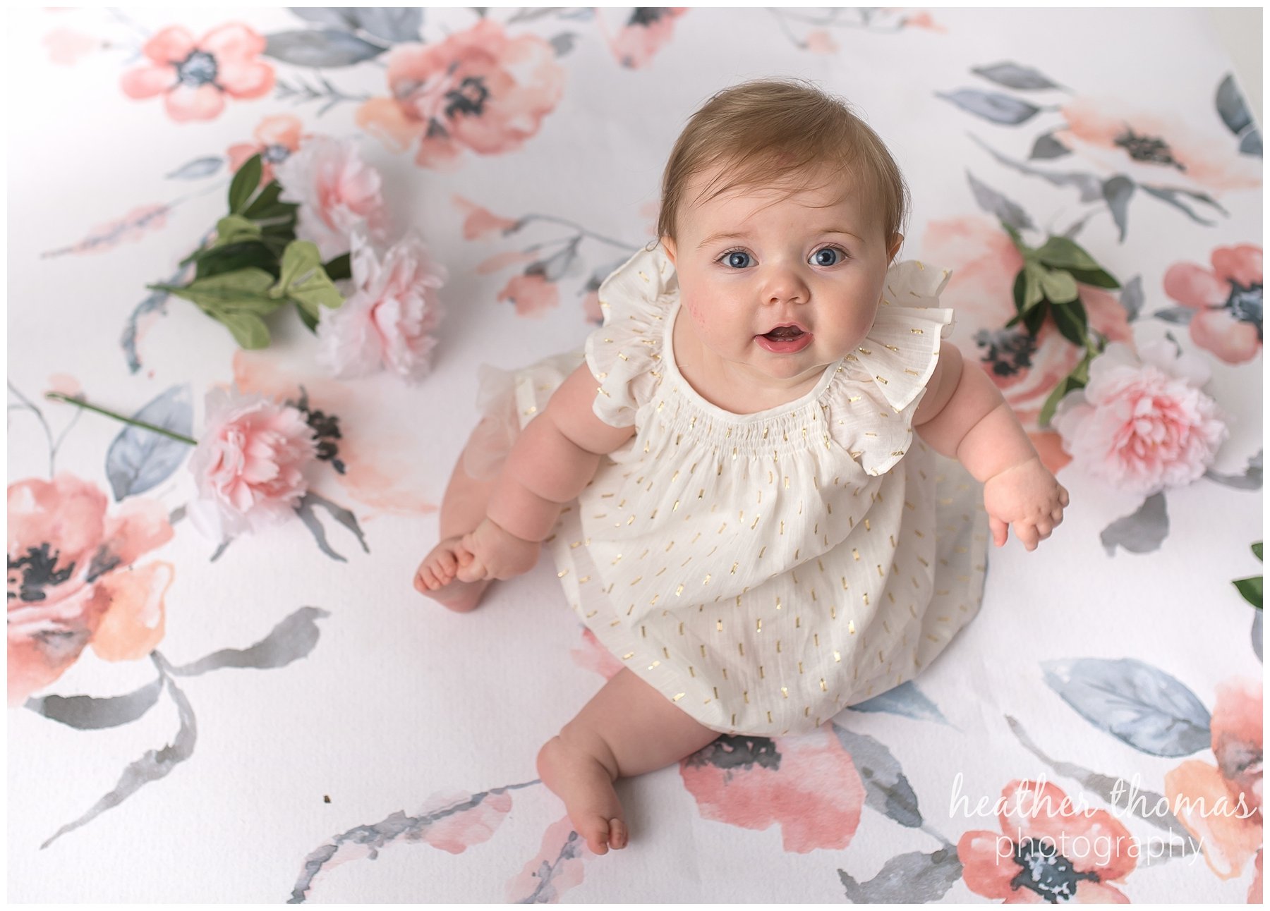 baby photo shoot philadelphia-23.jpg a 7 month old looking at the camera sitting on a pink backdrop in newtown pa