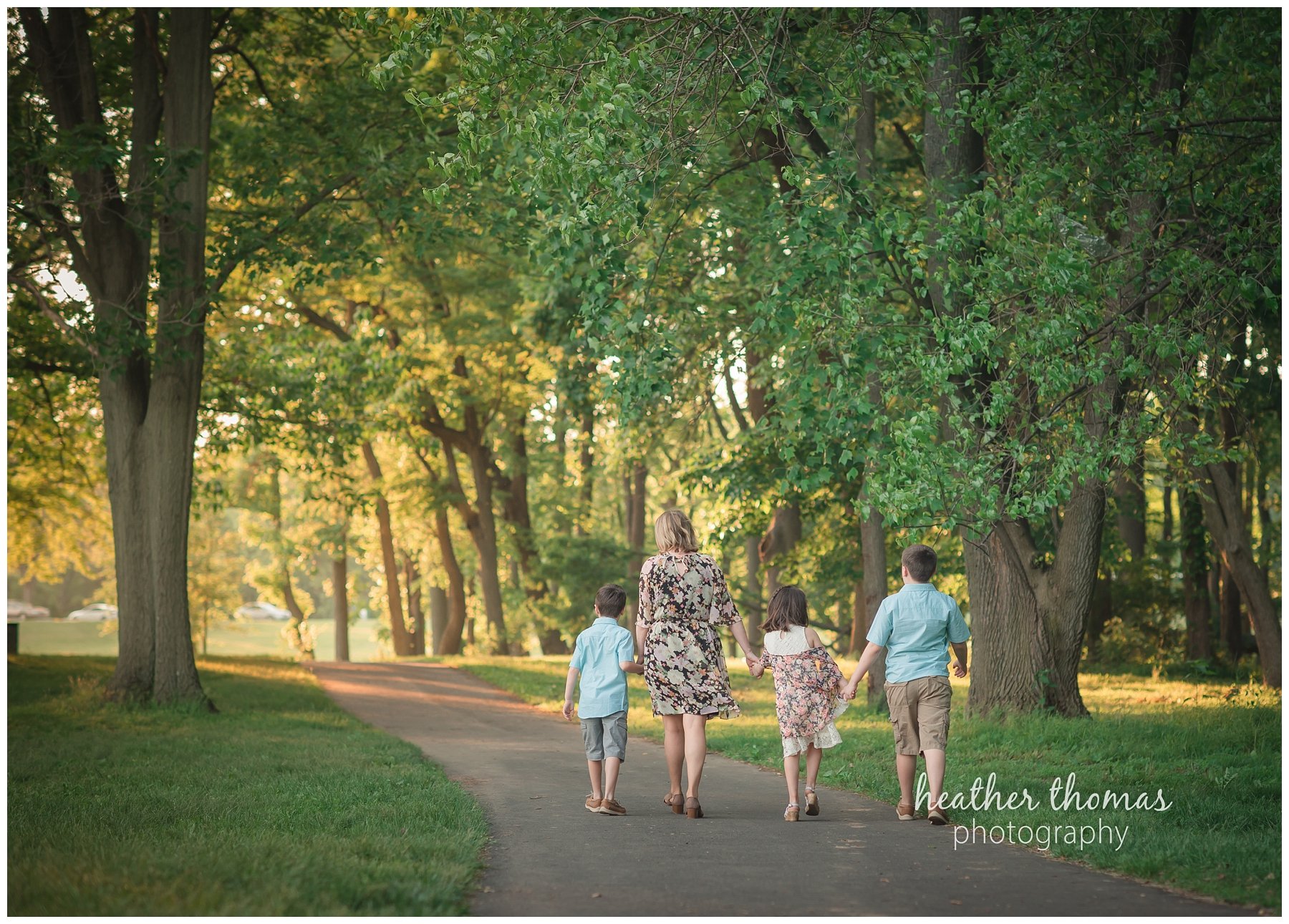 core creek family portrait-15.jpg a picture of a mother walking down the path with her three kids at core creek park