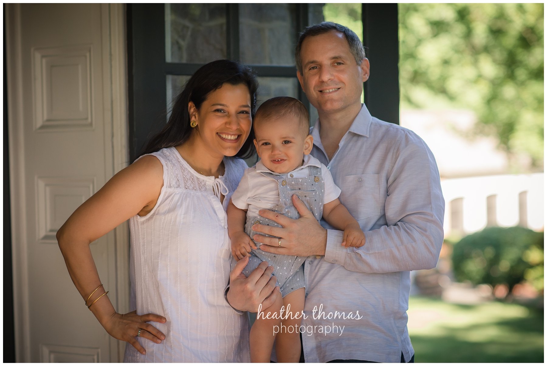 first birthday cake smash pesola-1.jpg a family of three with their one year old boy at their photography session in Newtown