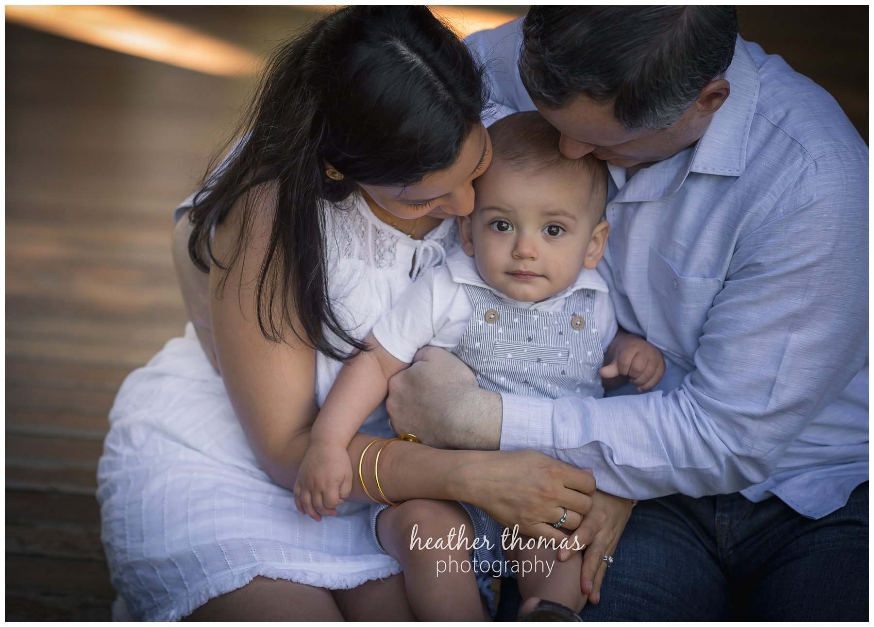 first birthday cake smash pesola-8.jpg a family of three with their one year old boy at their photography session in Newtown