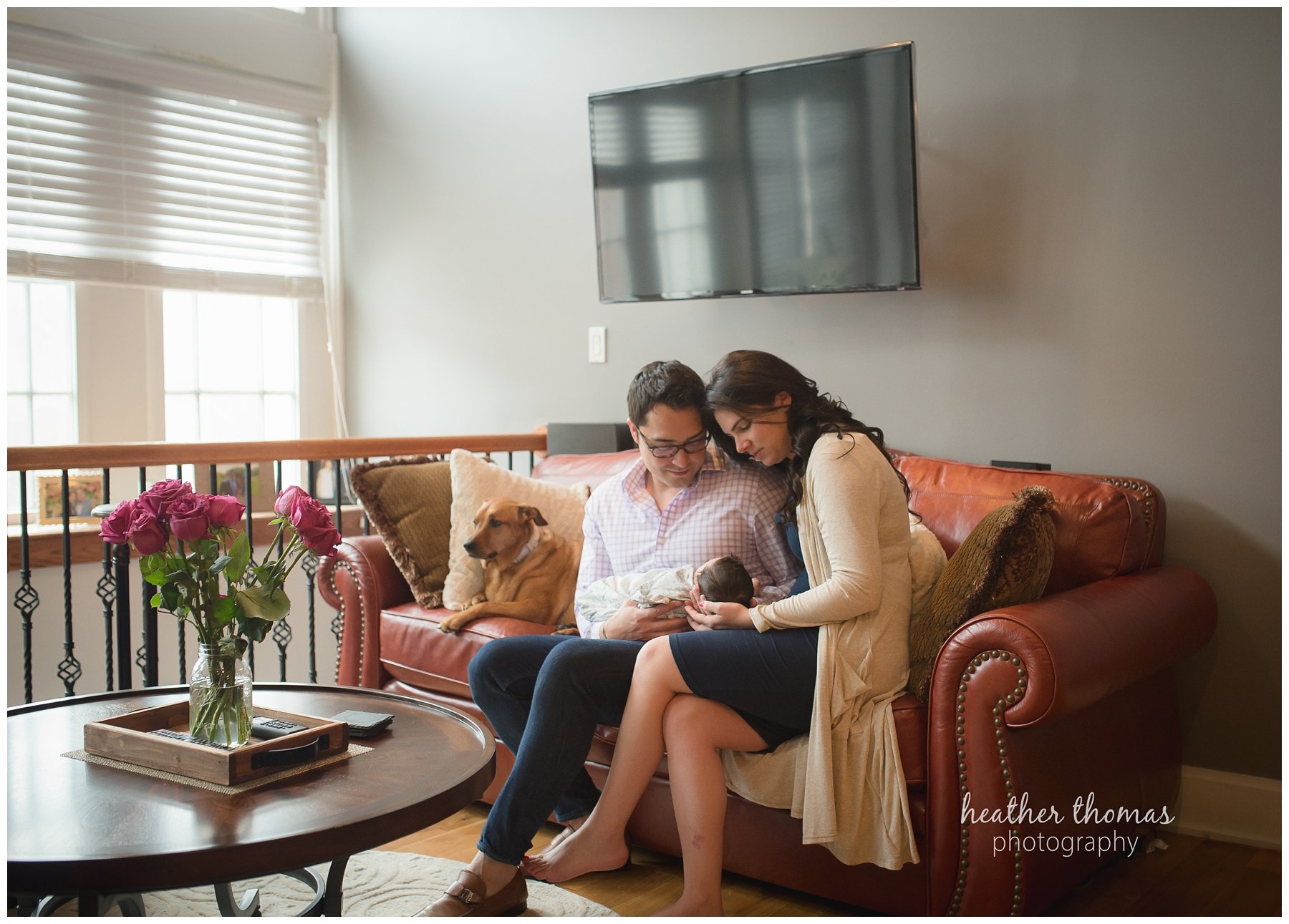 philadelphia lifestyle portraits-12.jpg a mother and father looking at their baby during newborn lifestyle photography session in philadelphia