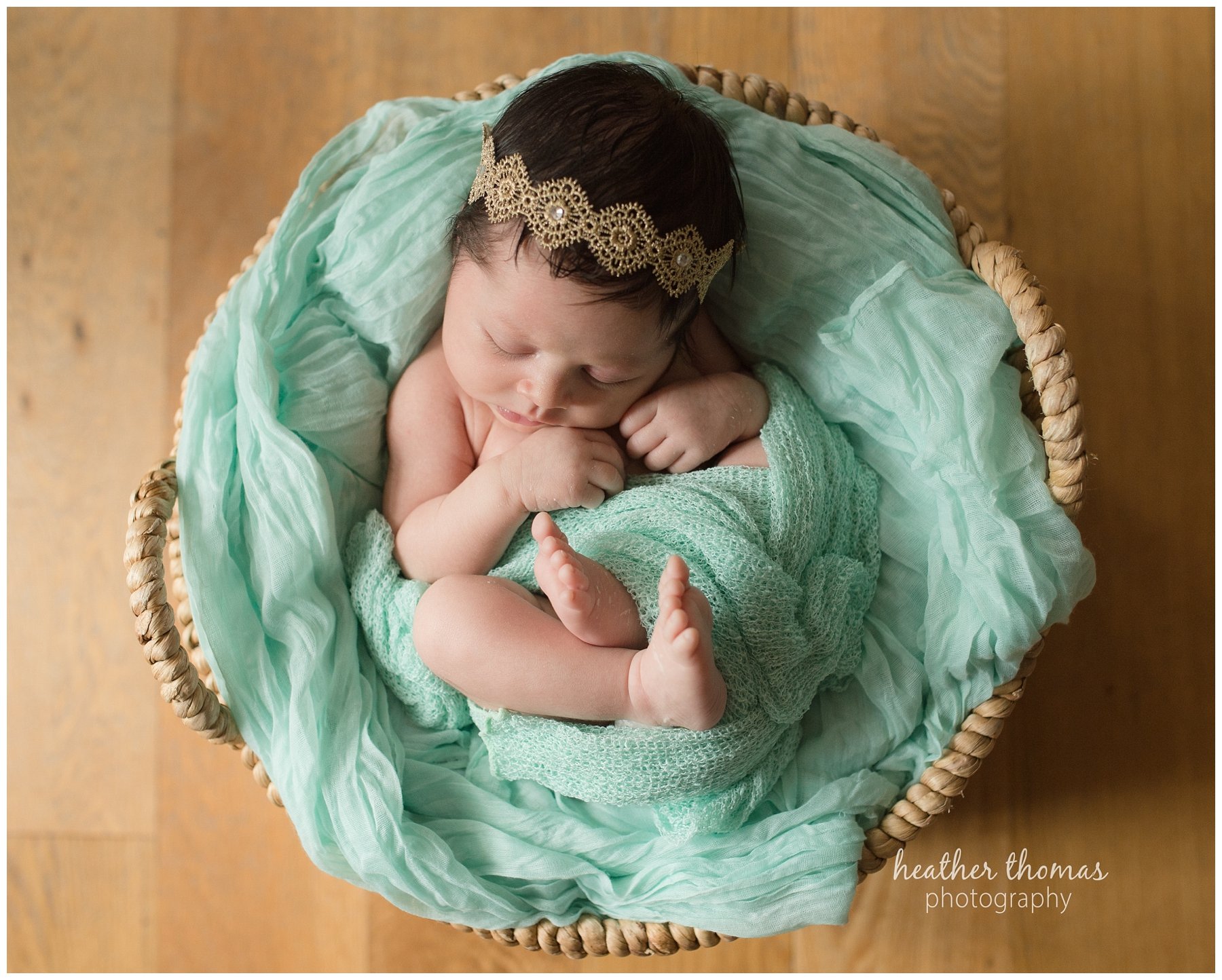 philadelphia lifestyle portraits-46.jpg a newborn baby girl wearing teal in a basket at a photo shoot in philadelphia