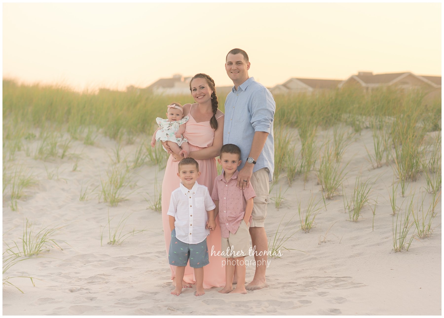 family beach photography ocnj-3.jpg a family of 5 wearing pink white and blue on the dunes in ocean city NJ