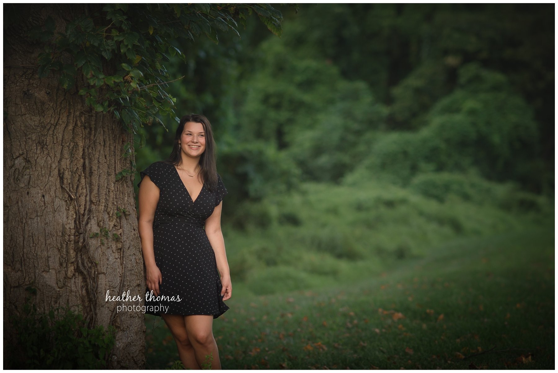 Senior Pictures Philadelphia-35.jpg a girl wearing a black dress leaning against a tree