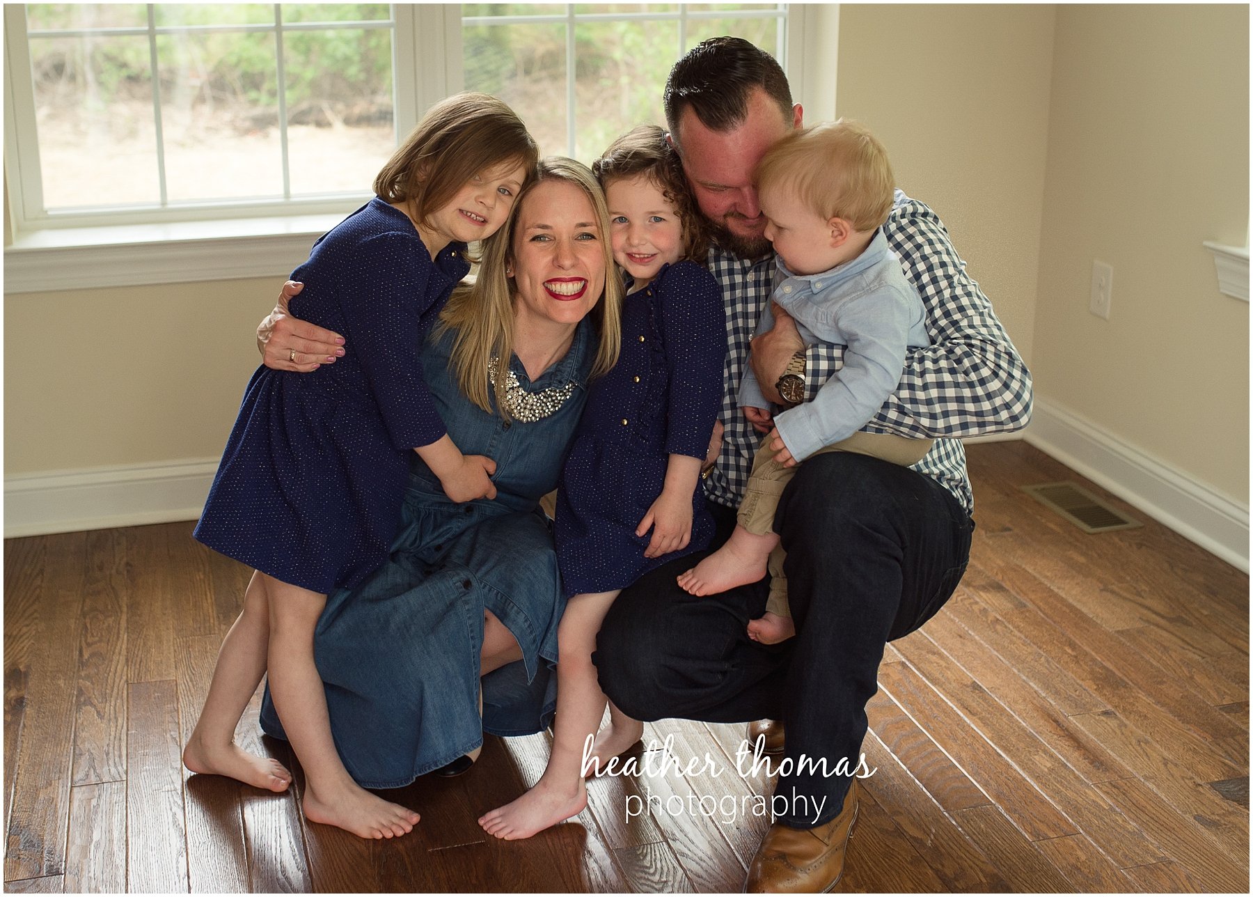 montgomery county family photographer-19.jpg a family of five inside their home in lansdale squeezing for a photo shoot with heather thomas