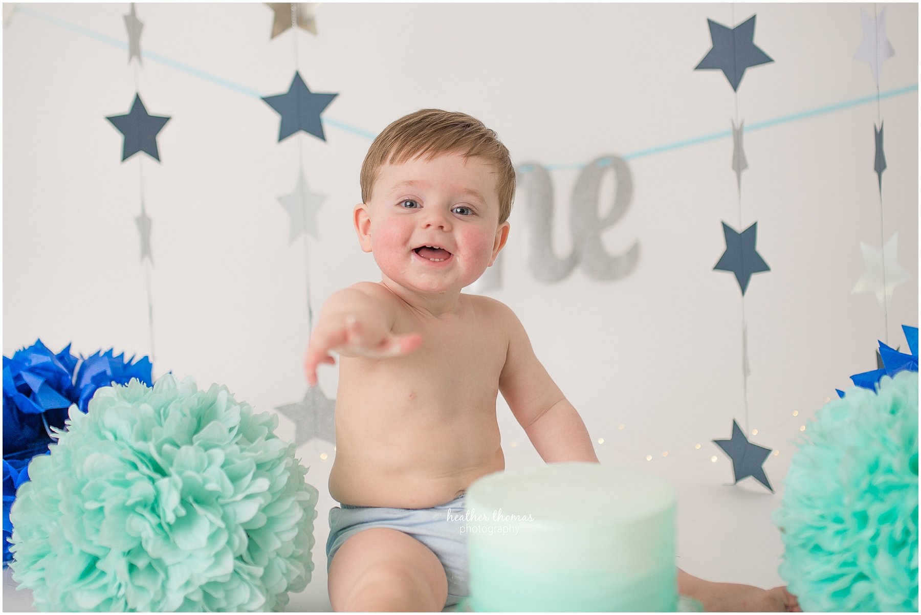 first birthday photos philadelphia-19.jpg a one year old boy sitting next to a cake at a cake smash photo shoot with heather thomas photography