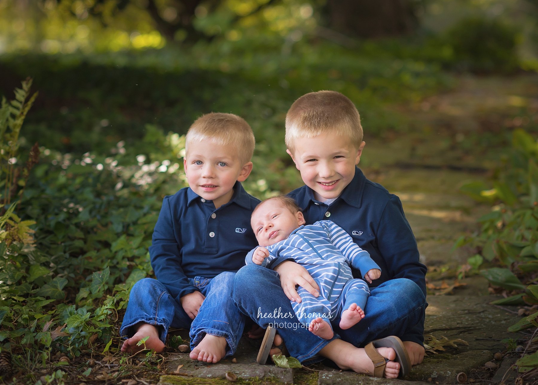 Bucks_County_PA_Newborn_Photography-29.jpg a picture of three boys sitting down smiling at the heather thomas photography studio in Newtown bucks county pa