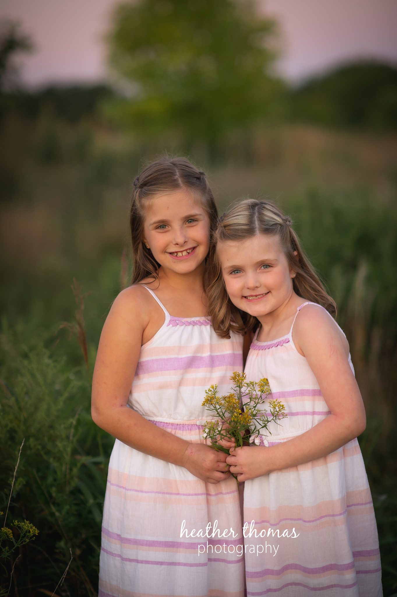 field family portraits in philadelphia a picture of two girls in a field for a photo shoot