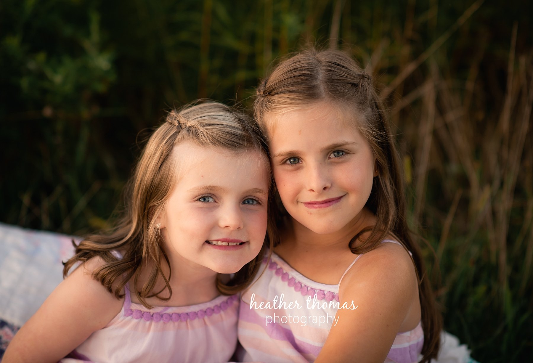 field family portraits in philadelphia a closeup picture of two sisters at a field in Philadelphia with heather thomas photography