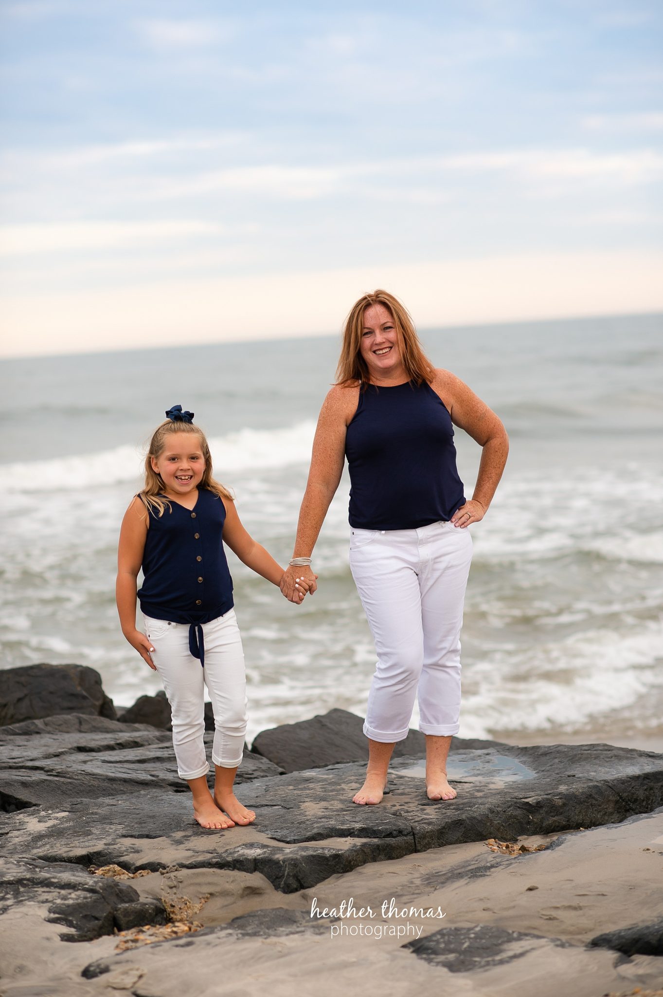 a family photo shoot in ocean city nj a picture of a mother and her daughter wearing blue and white on the beach in ocean city nj