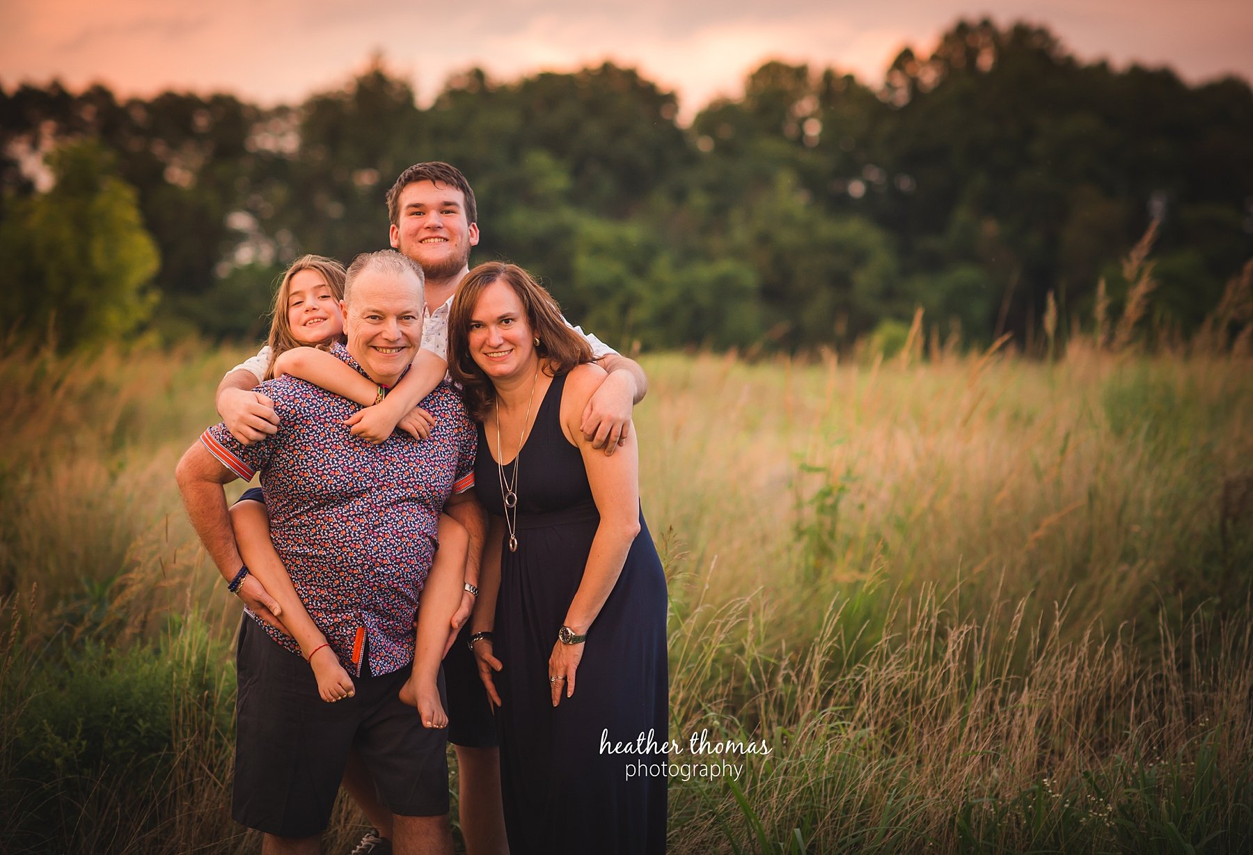 field family portraits in philadelphia a picture of a family outside in a field in philadelphia with heather thomas photography
