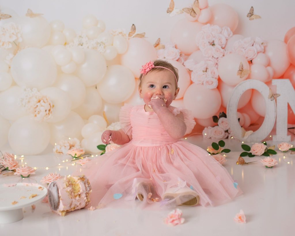 Philadelphia Birthday Photographer a one year old baby girl in pink cake smash with Philadelphia Cake Smash Photographer Heather Thomas