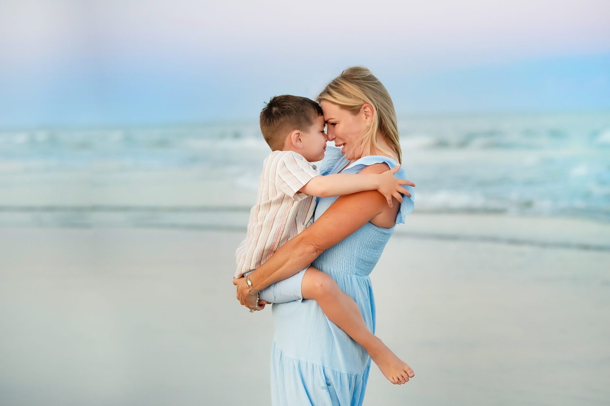Ocean City, NJ Photographer a portrait of a mother looking at her son on the beach at an ocean city nj beach photo shoot with heather thomas photography