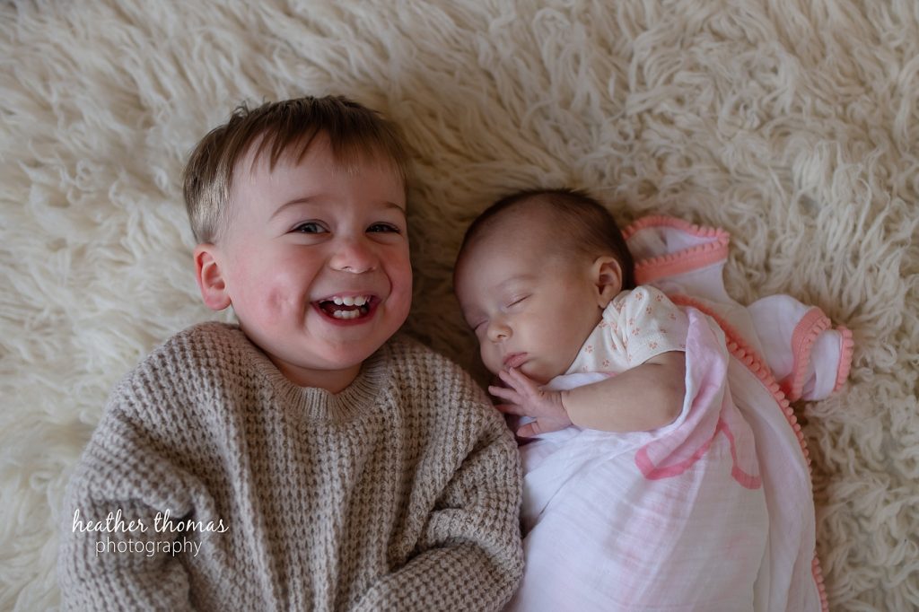 How to Prepare for an In-Home Shoot | Newborn Photography Philadelphia toddler giggles next to sibling by heather thomas photography