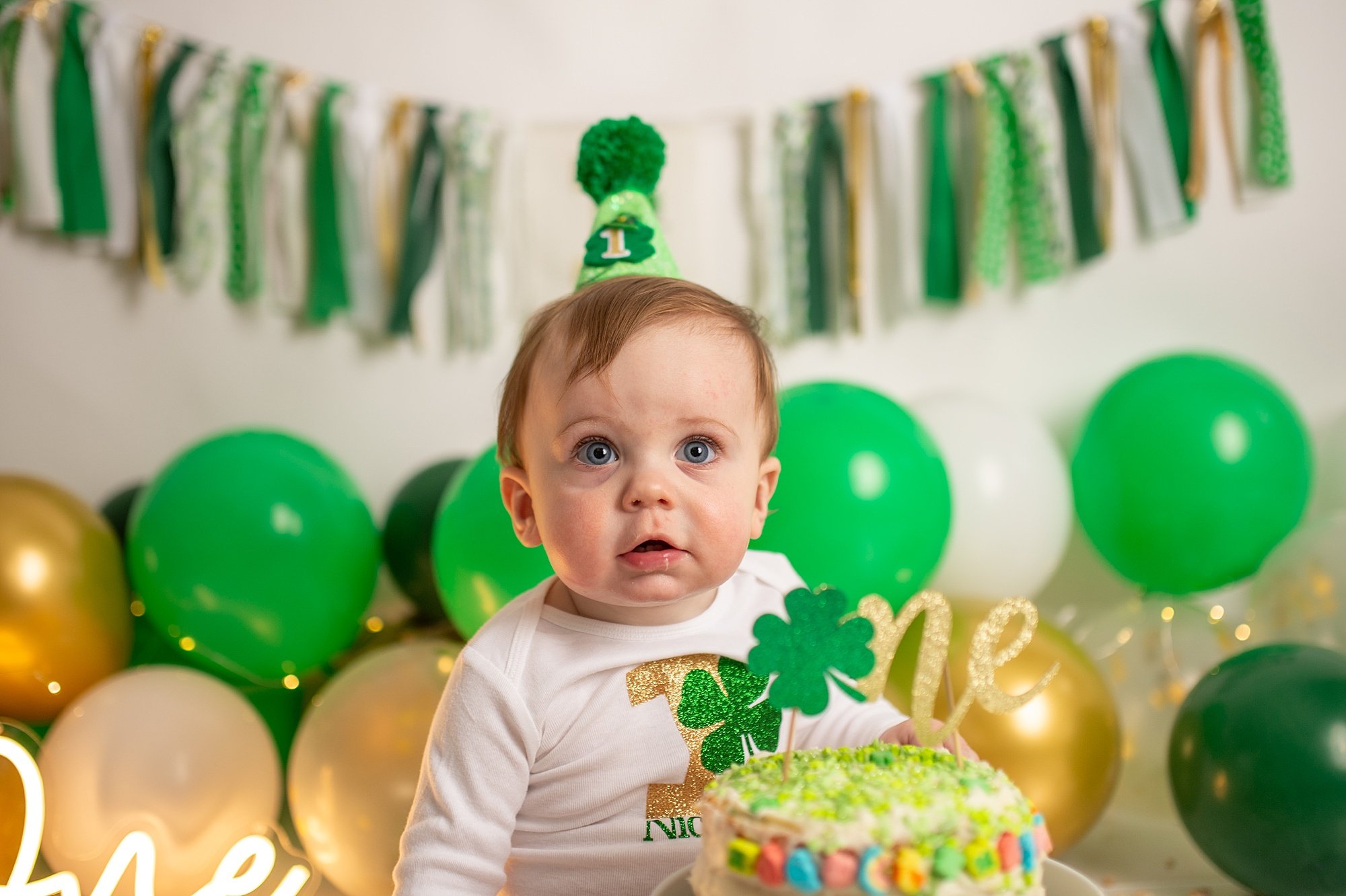 DCS_0891.jpg Philadelphia Cake Smash Photographer with baby in white and green at a lucky charm cake smash