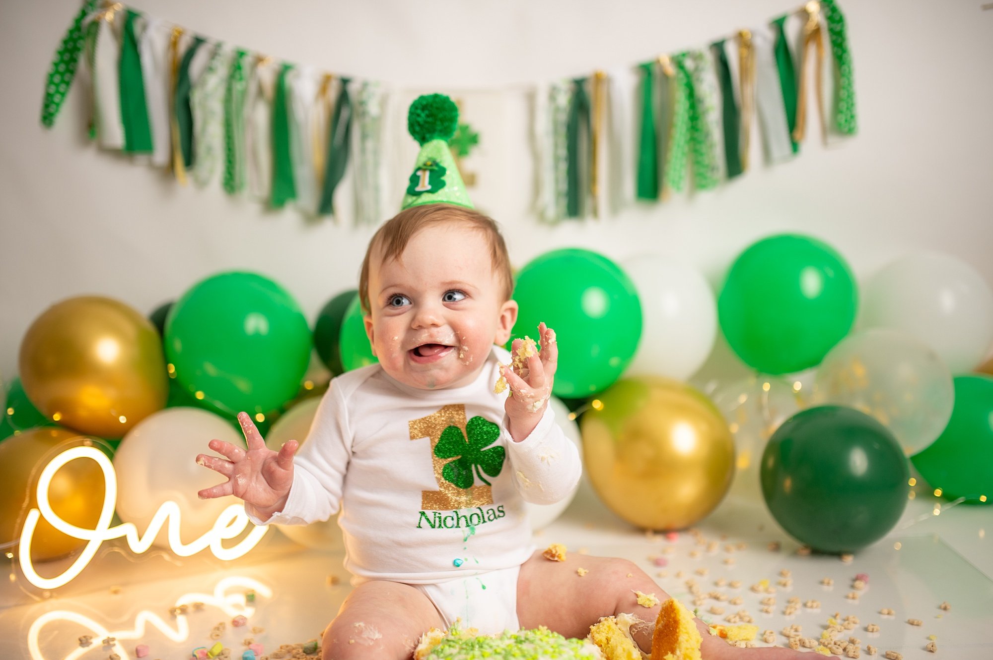 DCS_0915.jpg Philadelphia Cake Smash Photographer with baby in white and green at a lucky charm cake smash