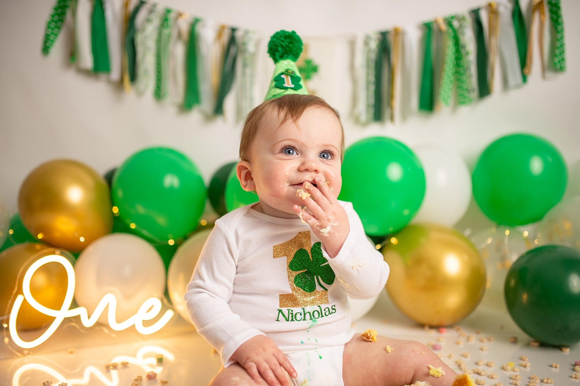DCS_0925.jpg green and gold balloons with a lucky charm cake smash in philadelphia