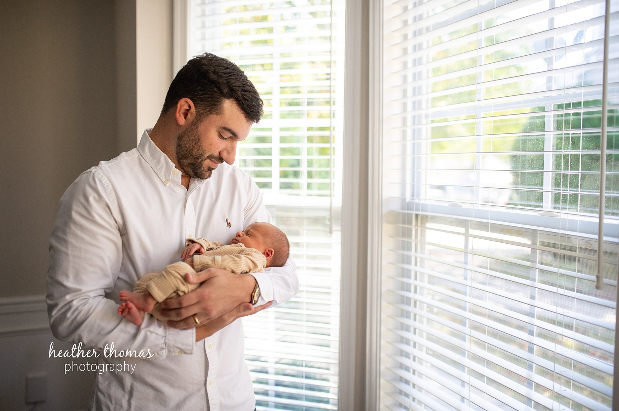 philadelphia-newborn-photogrpaher-heather-thomas-photography--02 a family holding a newborn boy during an in home lifestyle newborn photo session with heather thomas photography