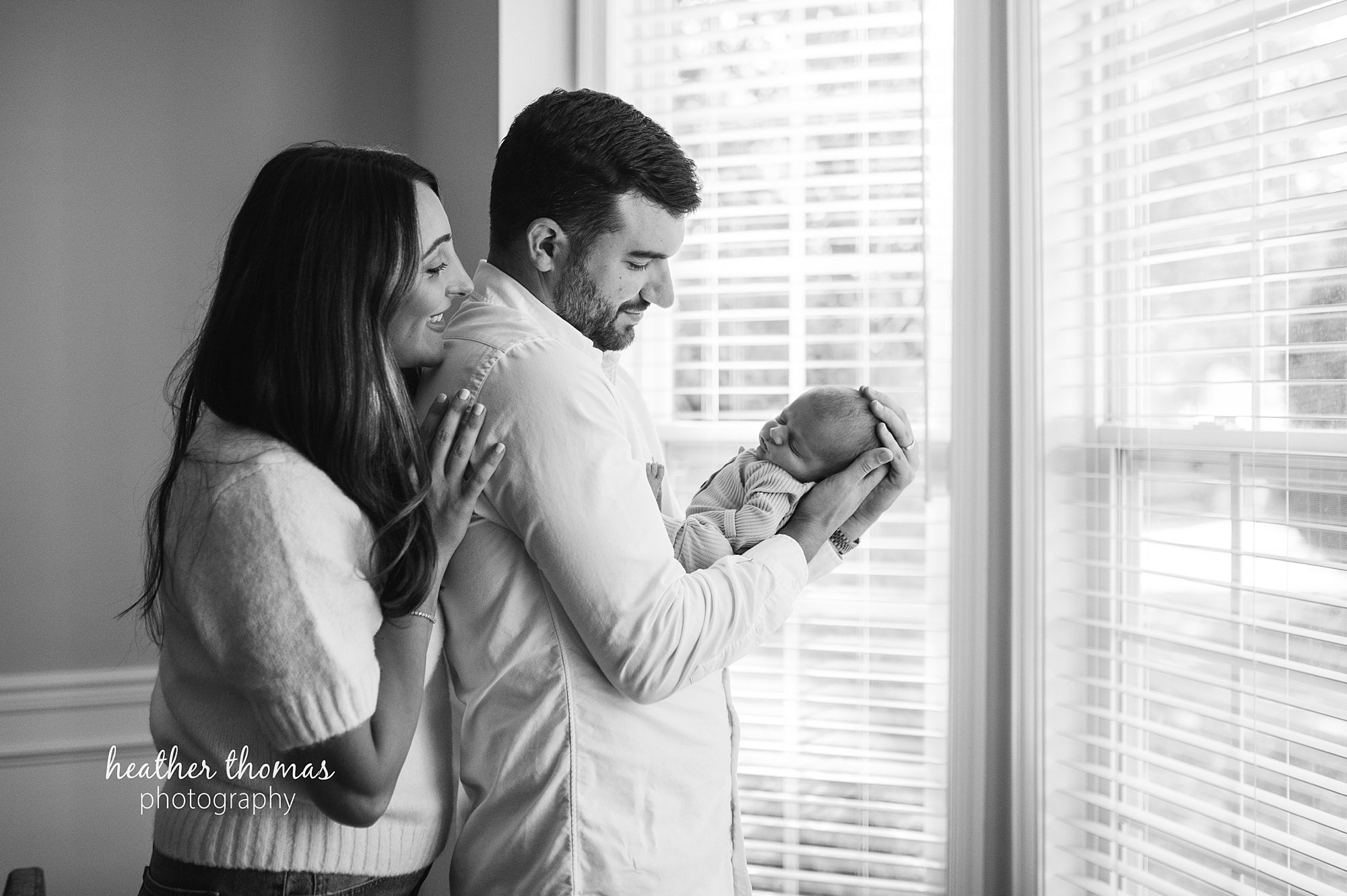 philadelphia-newborn-photogrpaher-heather-thomas-photography--02 a family holding a newborn boy during an in home lifestyle newborn photo session with heather thomas photography