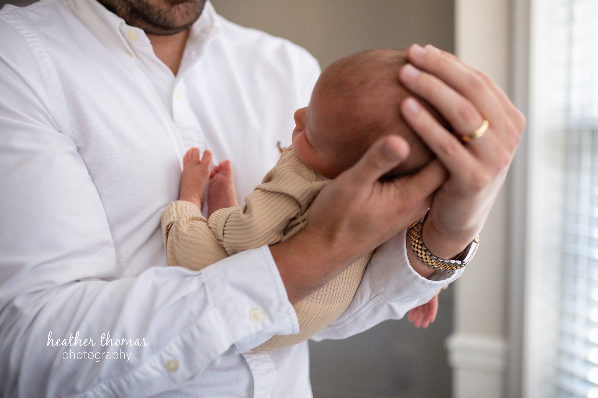 philadelphia-newborn-photogrpaher-heather-thomas-photography--02 a family holding a newborn boy during an in home lifestyle newborn photo session with heather thomas photography