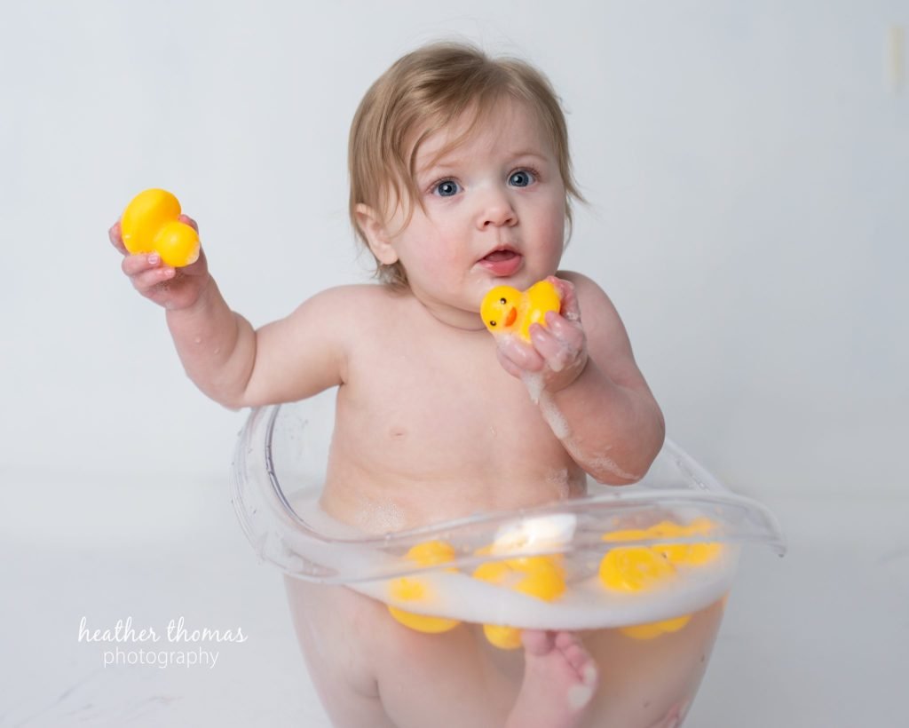 5 Things To#15 Ask Before Your Cake Smash Shoot | Bucks County Family Photographer blonde toddler sits in tub with rubber ducks by Heather Thomas Photography