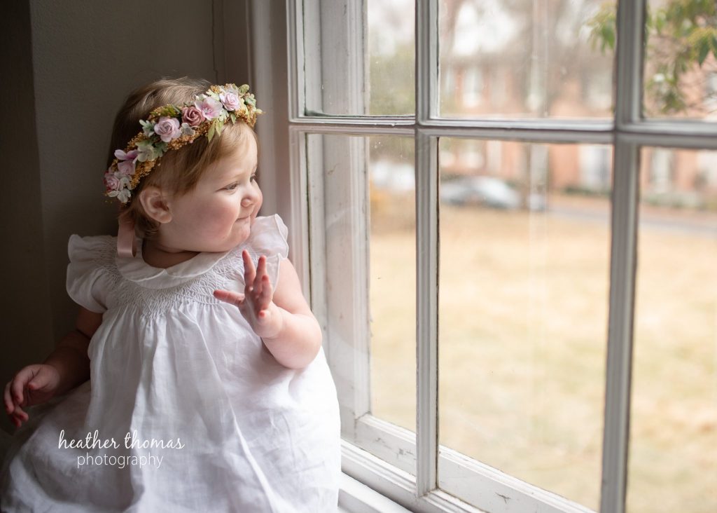 5 Things To#15 Ask Before Your Cake Smash Shoot | Bucks County Family Photographer small kid sits by window after parents learn 5 Things To Ask Before Your Cake Smash Shoot