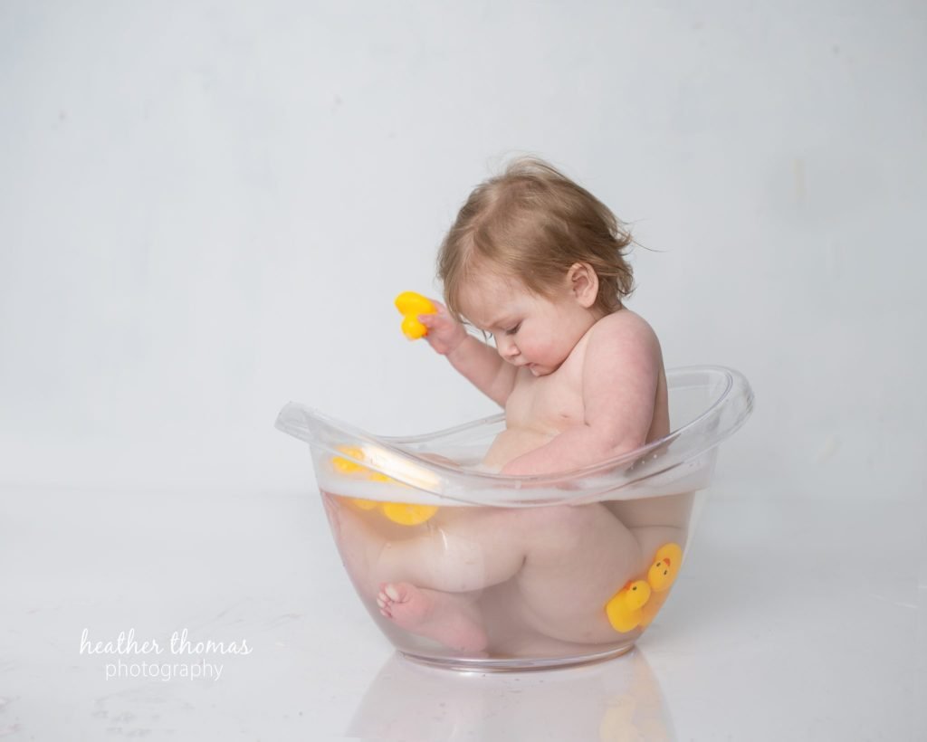 5 Things To#15 Ask Before Your Cake Smash Shoot | Bucks County Family Photographer baby sits in clear plastic tub after parents learn 5 Things To Ask Before Your Cake Smash Shoot