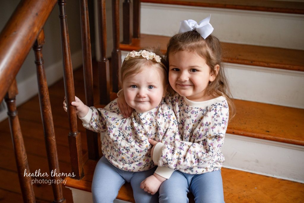 5 Things To#15 Ask Before Your Cake Smash Shoot | Bucks County Family Photographer little girls sit on family staircase by Heather Thomas Photography