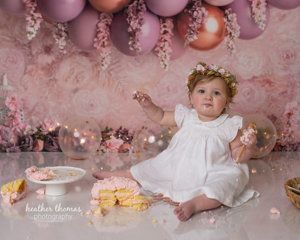 5 Things To#15 Ask Before Your Cake Smash Shoot | Bucks County Family Photographer toddler dips her hands in to cake by Bucks County Family Photographer