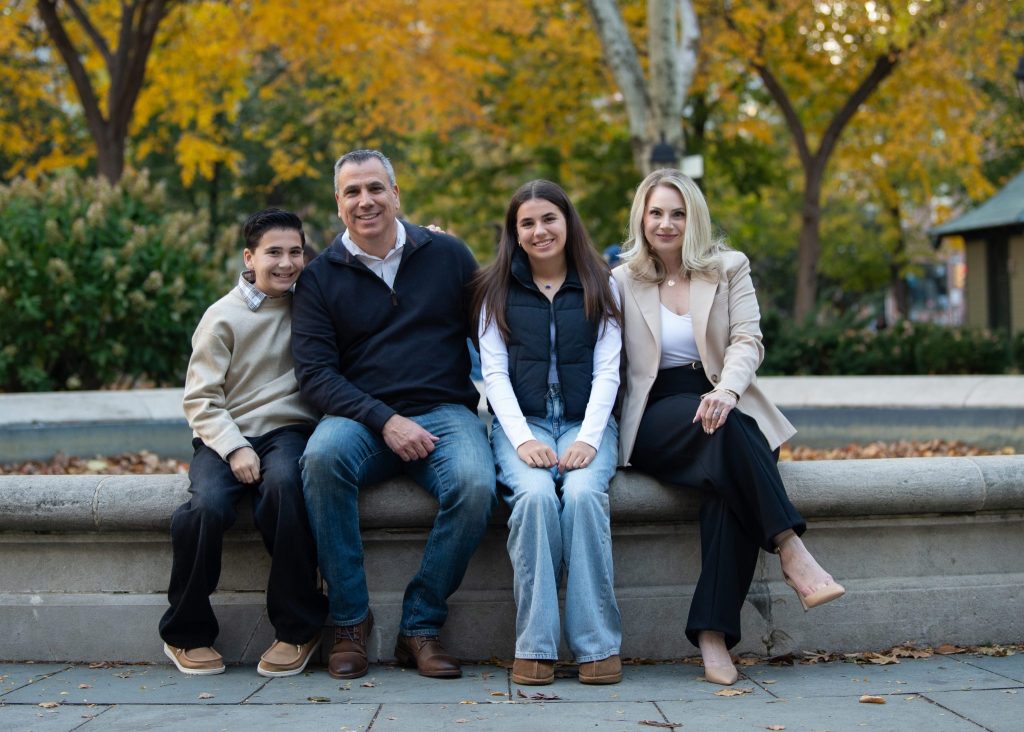 Washington Square Philadelphia Family Photography Session a family sitting at the fountain during their family photography session at washington square park philadelphia