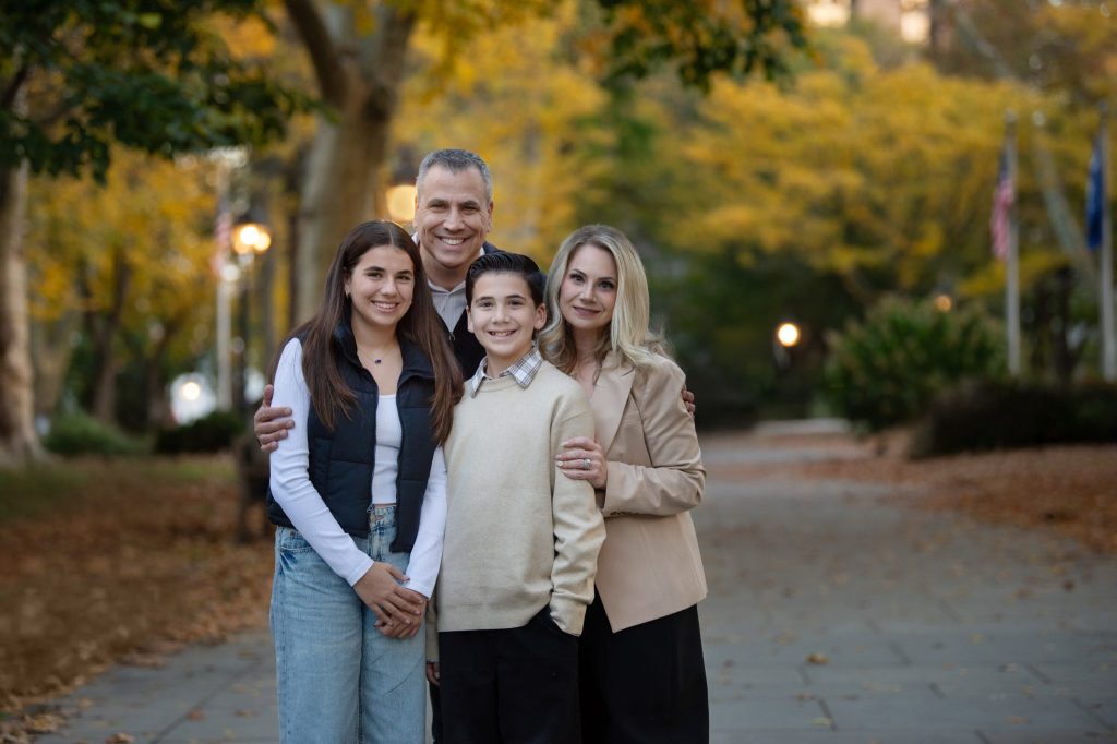 Washington Square Philadelphia Family Photography Session a family of four hugging on the path at their outdoor photo session in philadelphia