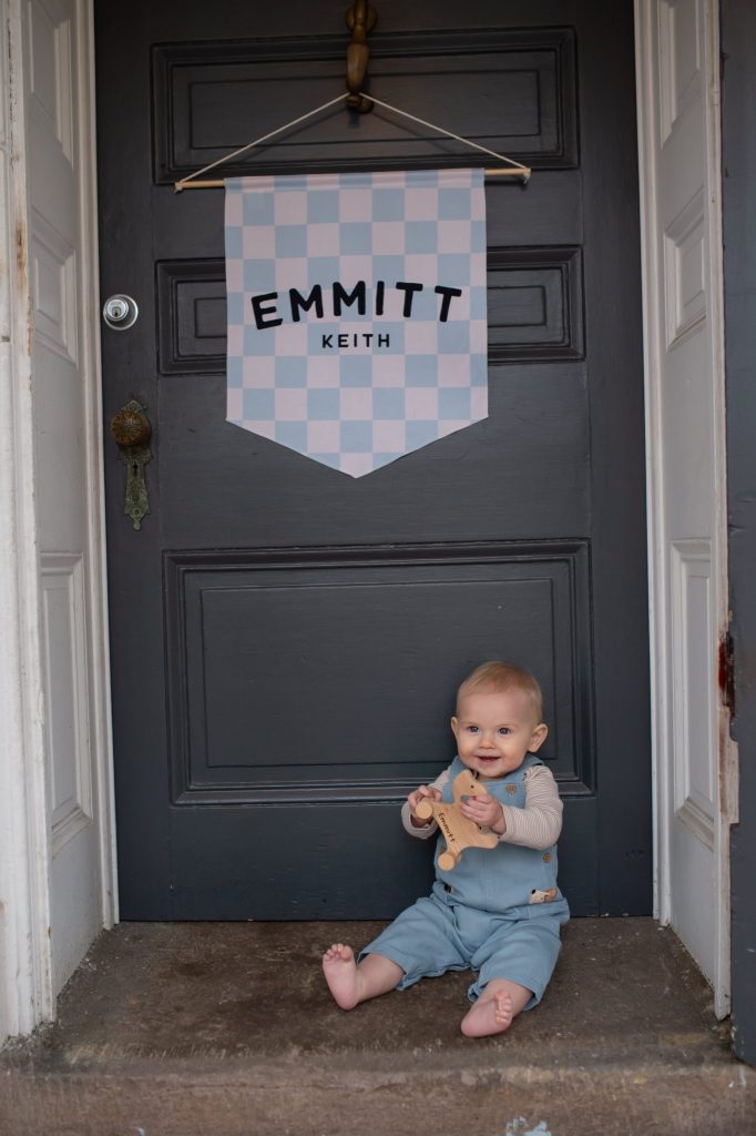 What Is a Cake Smash Photoshoot in Phildelphia? a boy sitting outside the studio in newtown pa at his first birthday cake smash photoshoot